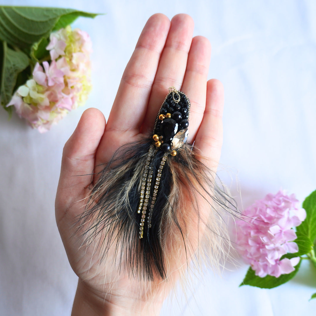 Handmade beaded bird TGbrooch with black and gold beads, gemstones and feathers