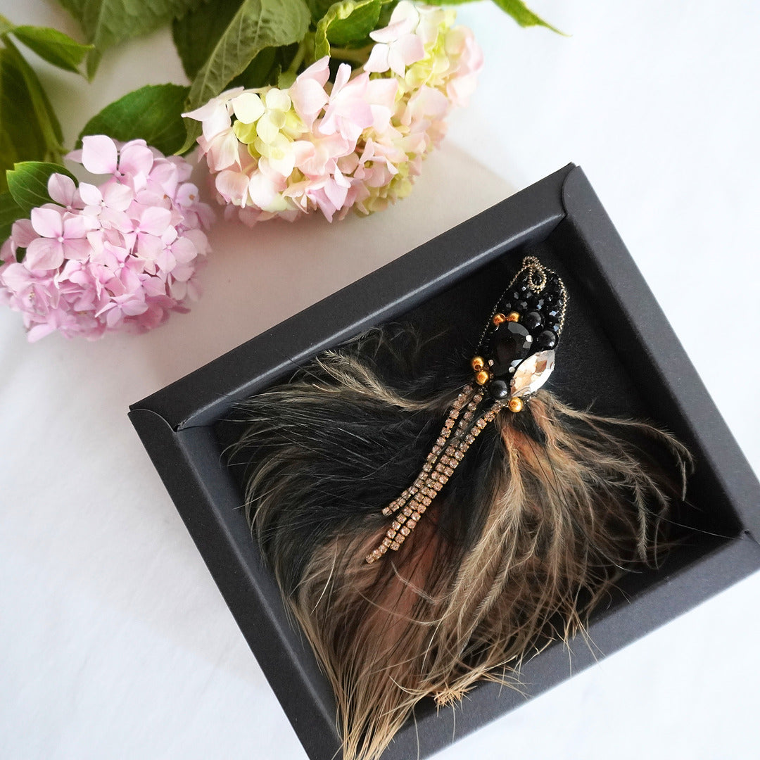 Handmade beaded bird brooch small size with black and gold beads, gemstones and feathers in a box