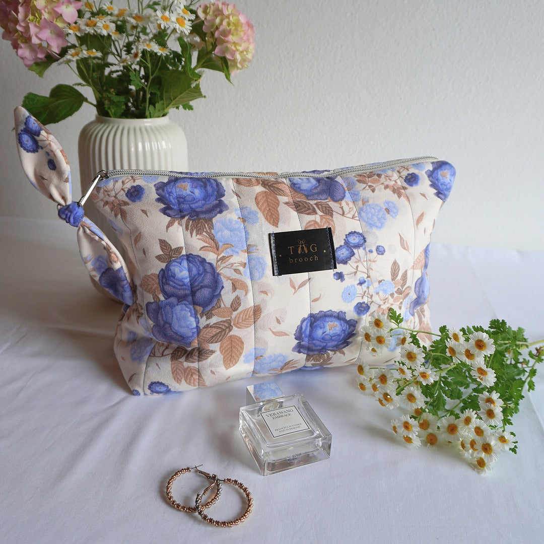 Handmade floral-patterned pouch with a TGbrooch tag and blue roses on beige background