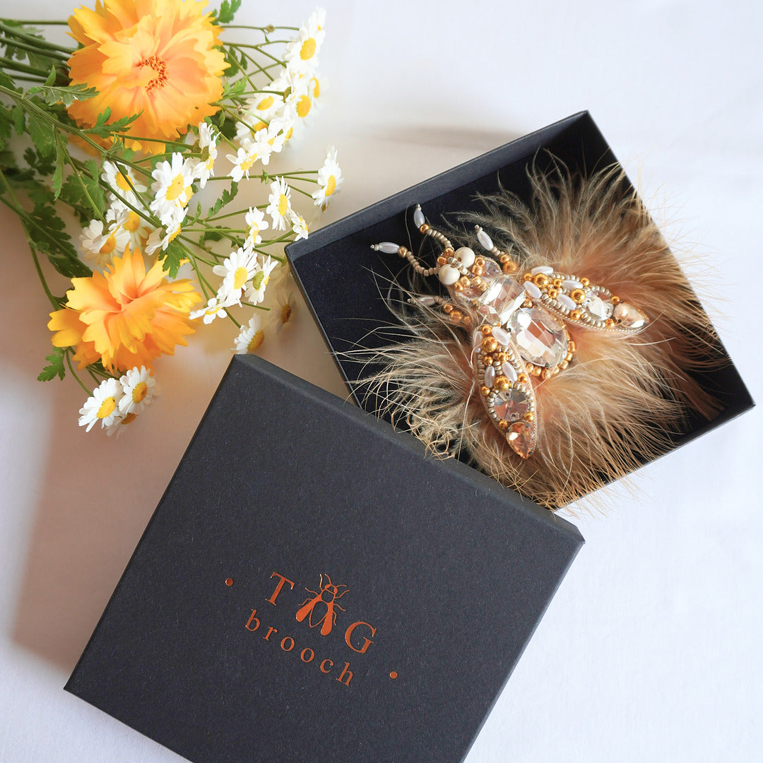 Embroidered beaded fly brooch in gold and champagne color combination, feathers and gemstones in TGbrooch box