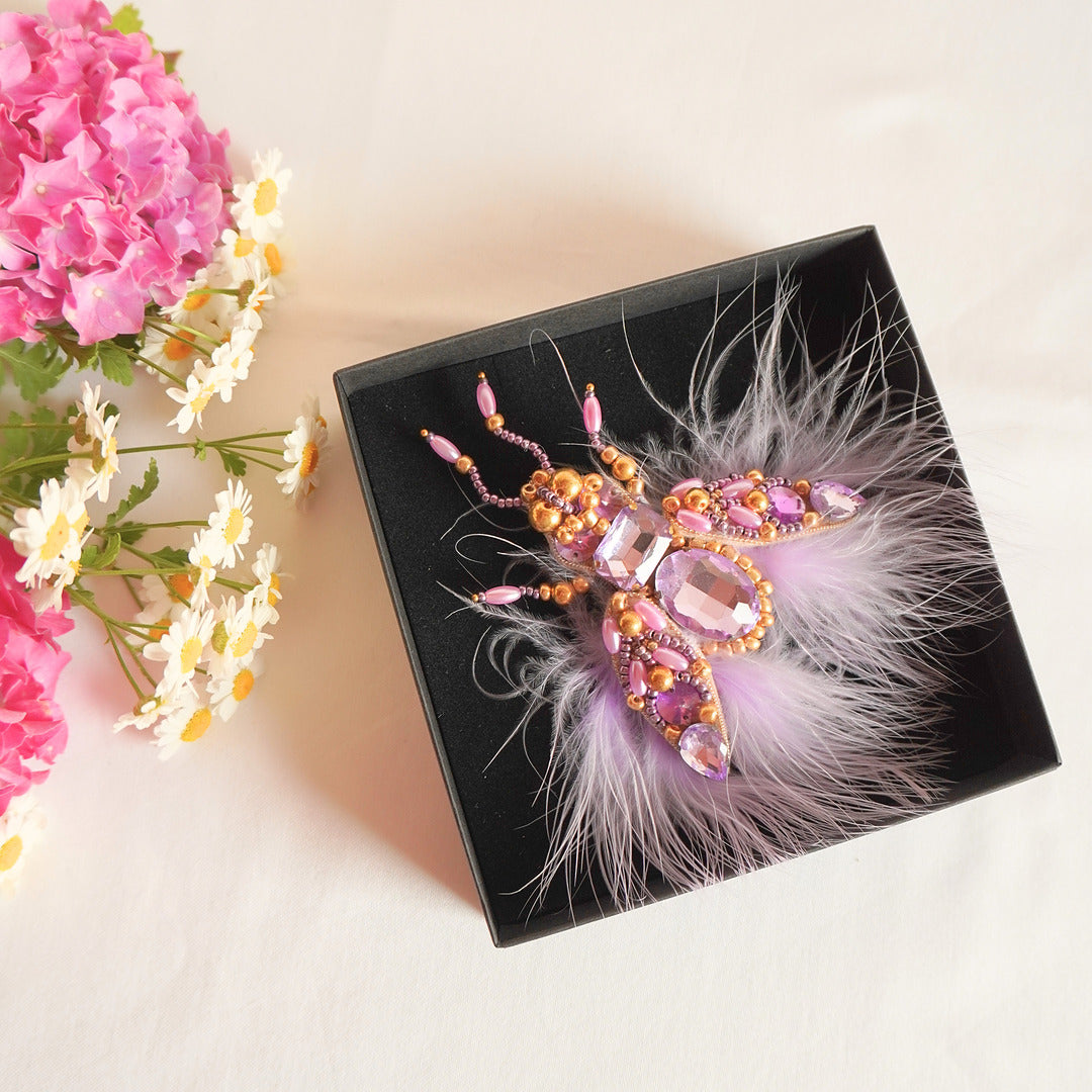 Handmade beaded fly brooch with purple feathers and gemstones, embroidered by TGbrooch