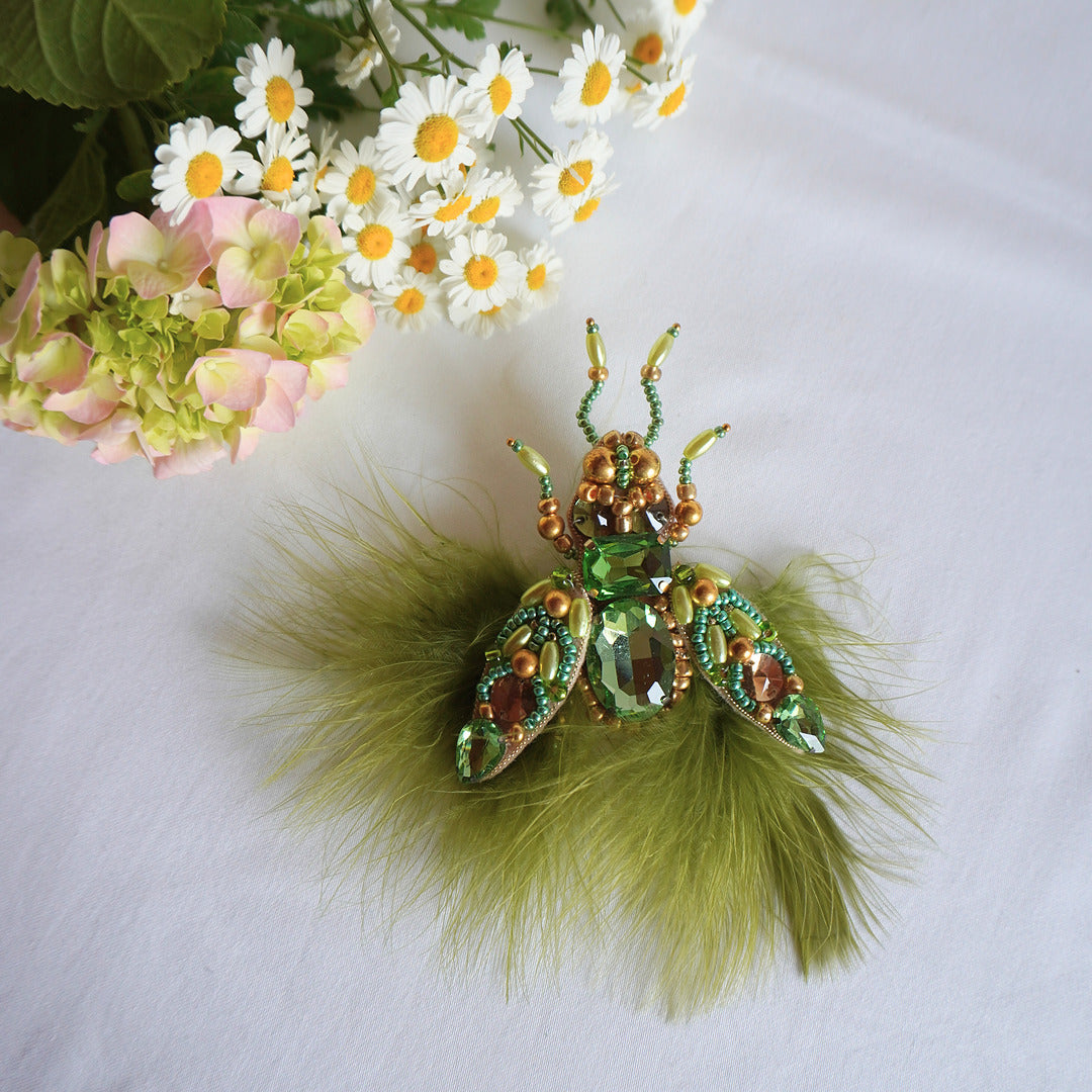 Decorative beaded insect brooch with green feathers - TGbrooch