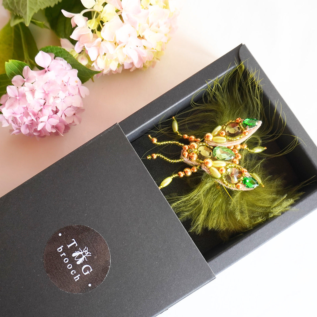 Lovely beaded TGbrooch in olive green and gold color combination in a box