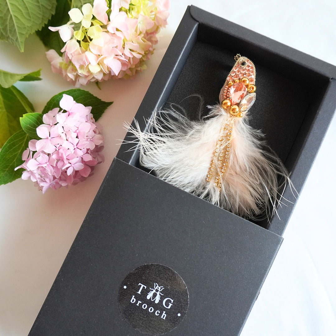 Handmade embroidered beaded bird brooch in peach and gold color combination in TGbrooch box