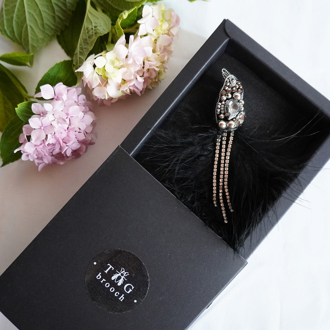 Handmade beaded bird brooch with silver and black gemstones, beads and feathers in TGbrooch box