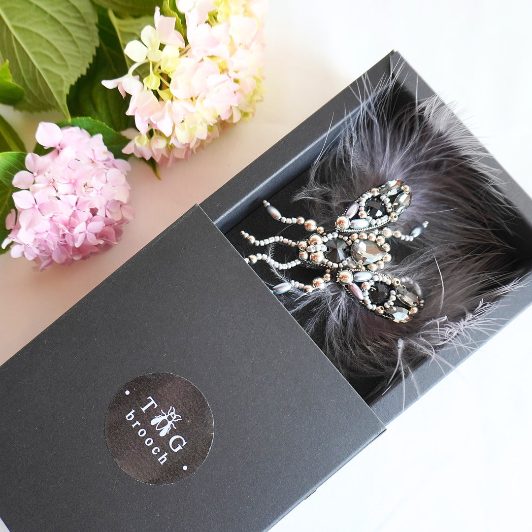 Lovely handmade fly beaded brooch with black and silver beads, gemstones and feathers in a TGbrooch box