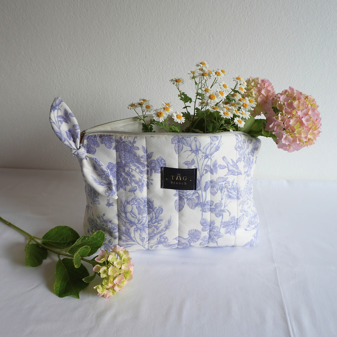 Medium size cosmetic bag handmade by TGbrooch with a floral pattern in white and blue color combination printed on velvet