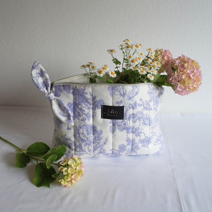 Medium size cosmetic bag handmade by TGbrooch with a floral pattern in white and blue color combination printed on velvet
