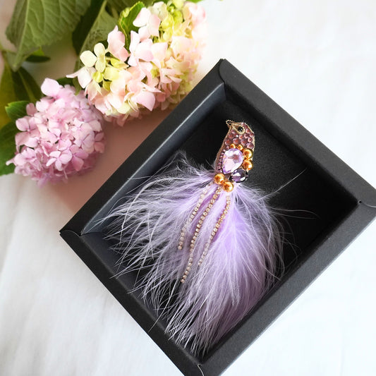 Handmade beaded bird brooch small size with lilac purple and gold beads, gemstones and feathers in a box