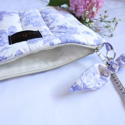 Detail of handmade quilted bag with floral pattern and opened silver zipper - TGbrooch