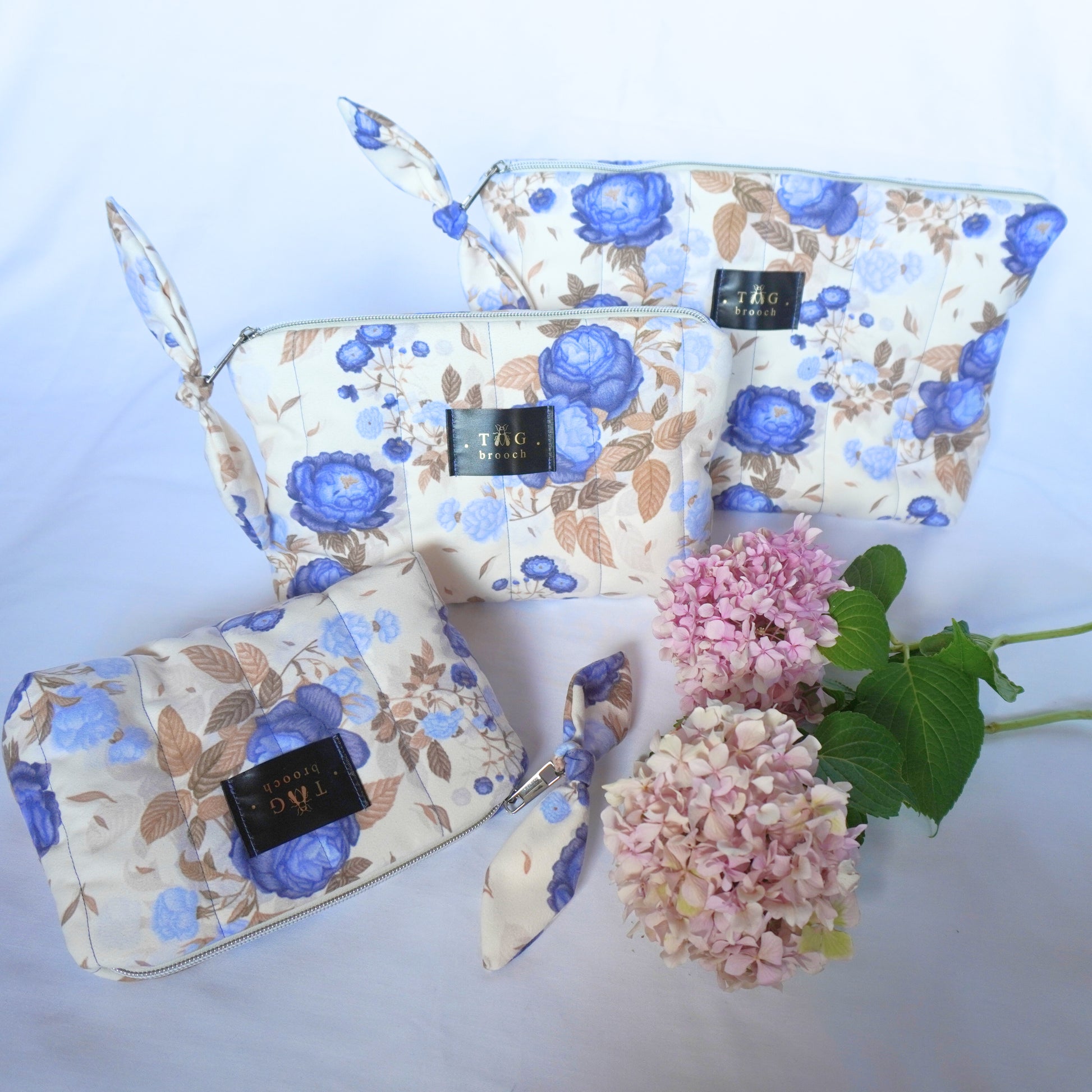 Set of handmade quilted toilerty bags with floral blue roses pattern print designed by TGbrooch